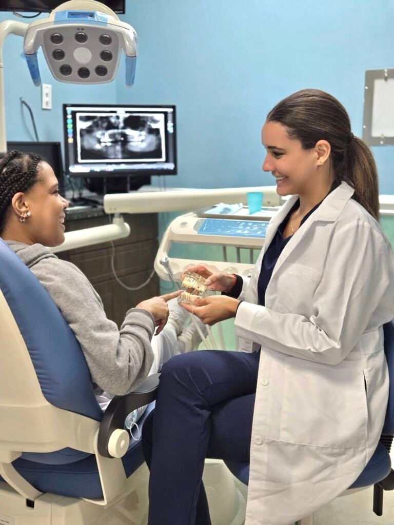 Dr. Adeleydis Quintana in consultation with a client at Q Smiles Dentistry